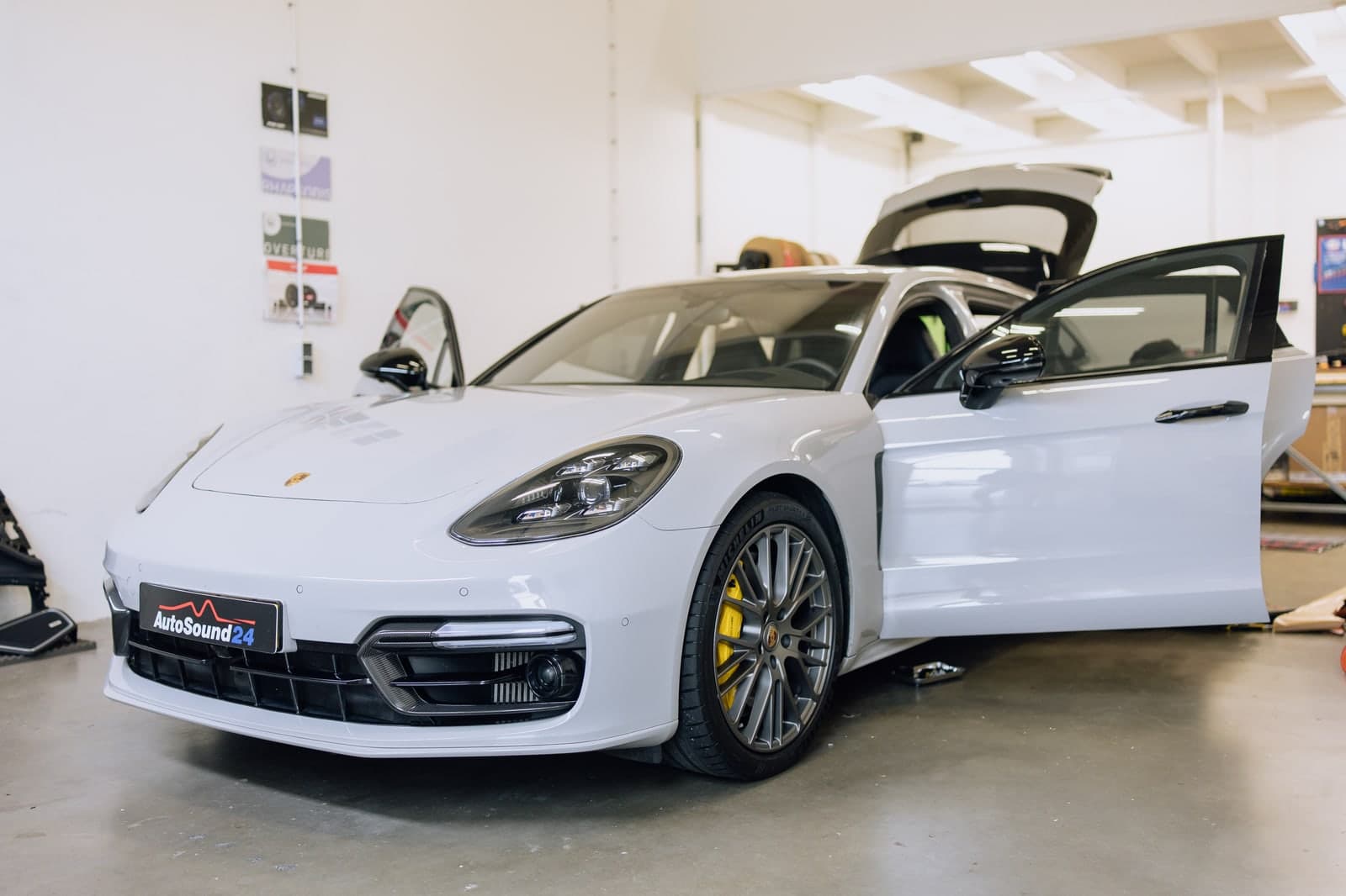 White Porsche Panamera inside the AutoSound24 installation workshop at Tocht 18 in Obdam